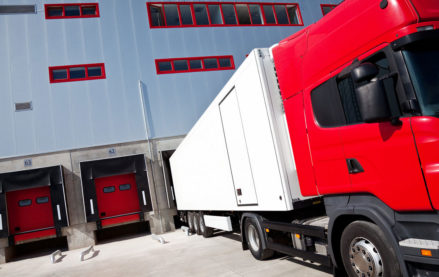 Trucks in bays at a 3PL logistics warehouse