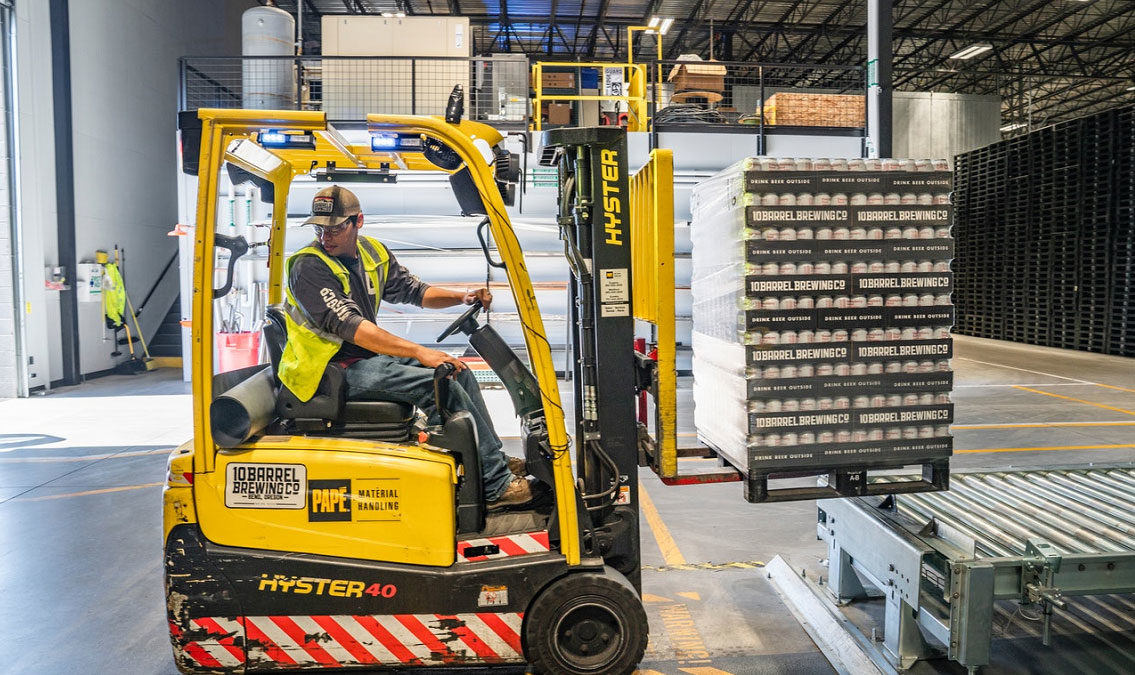 Worker operating a forklift at a warehouse in receiving