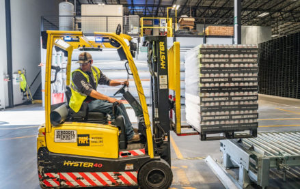 Worker operating a forklift at a warehouse in receiving