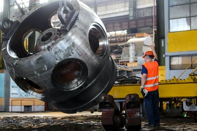 Worker performing preventive maintenance on equipment