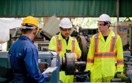 Workers performing maintenance on facility equipment