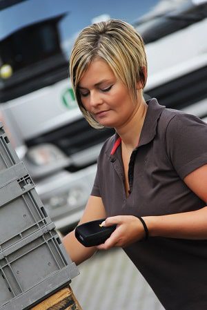 Warehouse worker scanning pallets as part of a warehouse barcoding plan