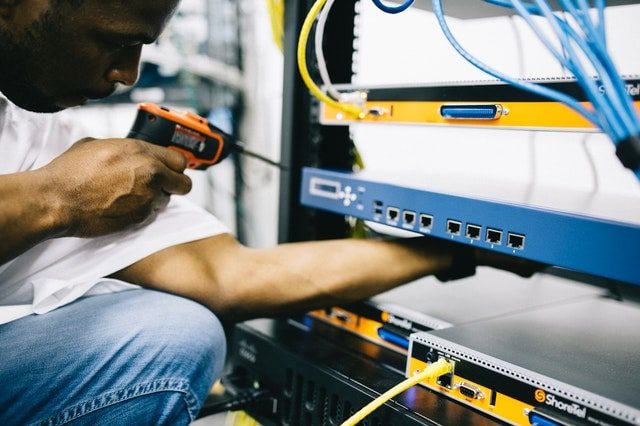 Field maintenance worker repairing an issue