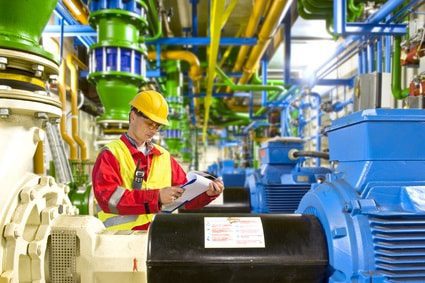 Facility worker reviewing a safety and compliance checklist before operating equipment 