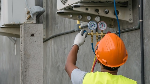 Technician performing preventive maintenance on HVAC