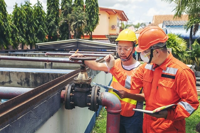 Technicians performing maintenance on wastewater management system