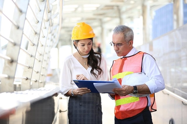 Facility managers discussing maintenance management processes