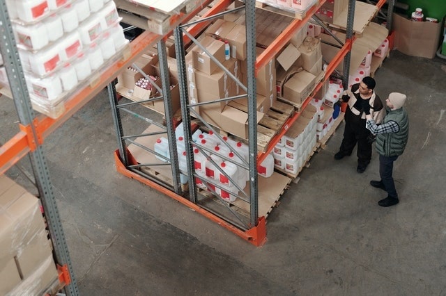 Warehouse workers picking products using inventory system