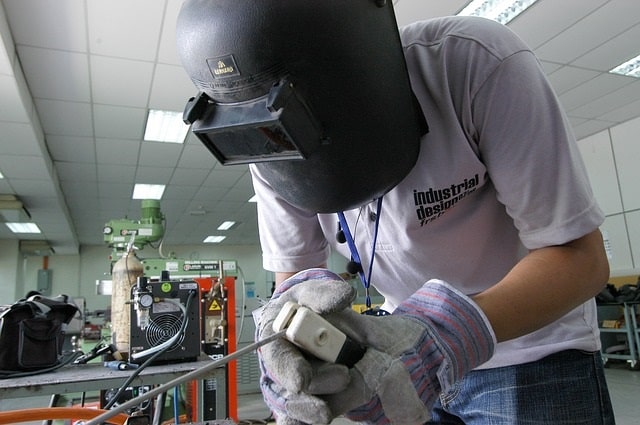 Welder working with company assets