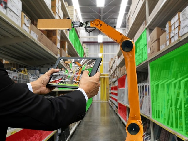Person holding a tablet in front of ASRS system in a warehouse
