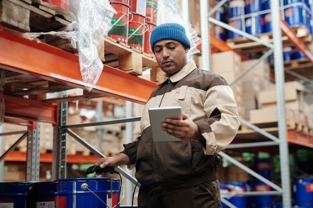 Warehouse worker scanning a barcode label with a scanner
