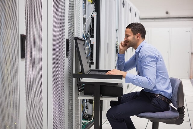 Man performing maintenance on servers and IT assets