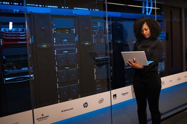 Woman checking status of servers in a data center