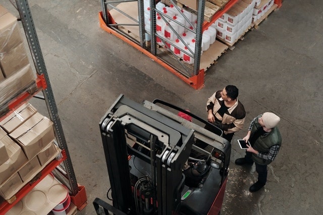 Woman working on warehouse receiving with computer software