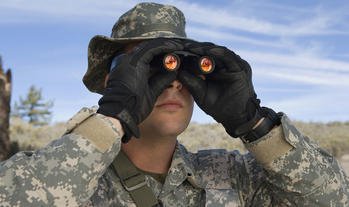 U.S. military personnel looking through binoculars