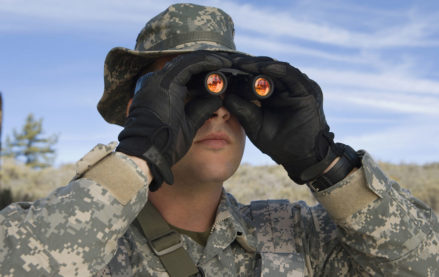 U.S. military personnel looking through binoculars