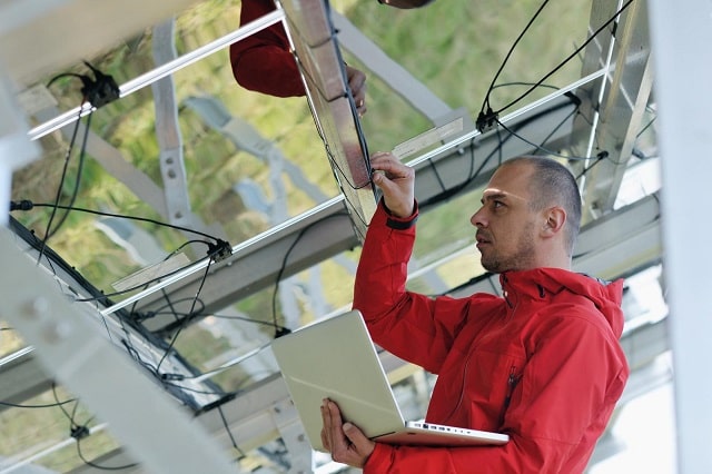 Field service worker performing maintenance on equipment 