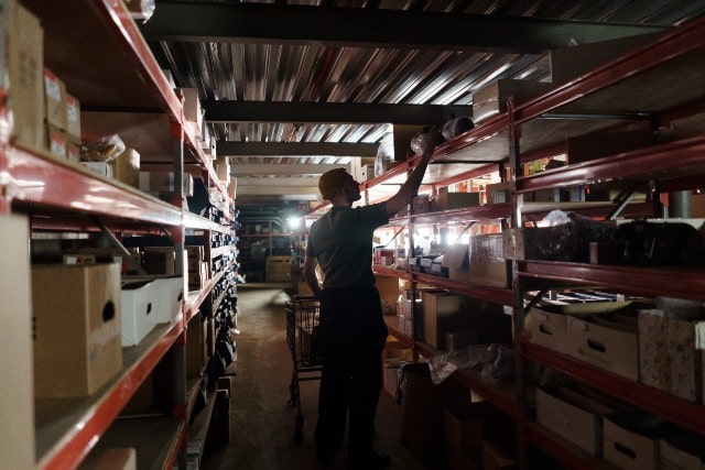 Warehouse worker removing items from a shelf