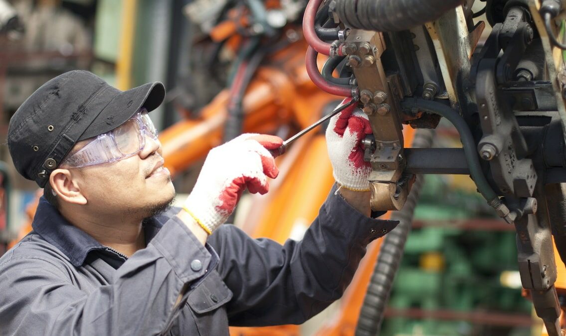 Mechanic Repairing a Machine