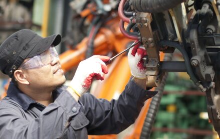 Mechanic Repairing a Machine