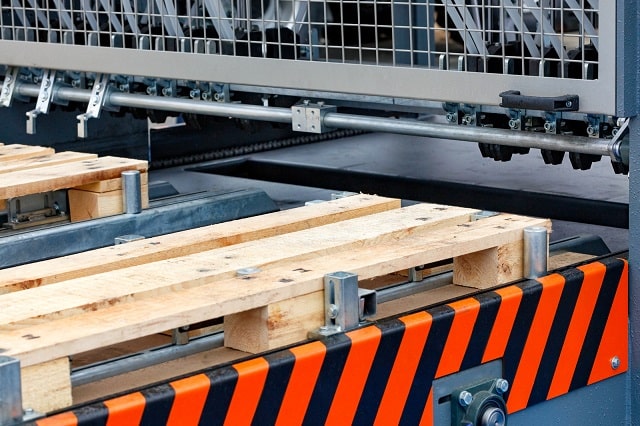 Wooden planks moving through production facility