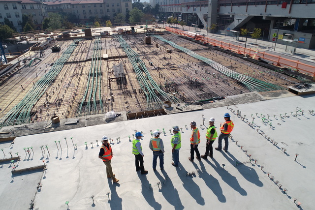 Team of workers overlooking an industrial space