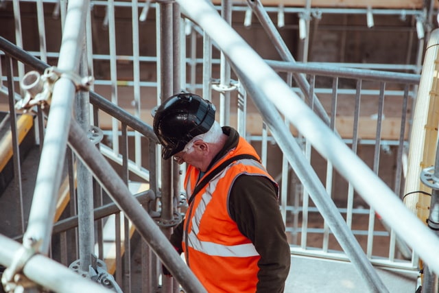 Worker moving through scaffolding 