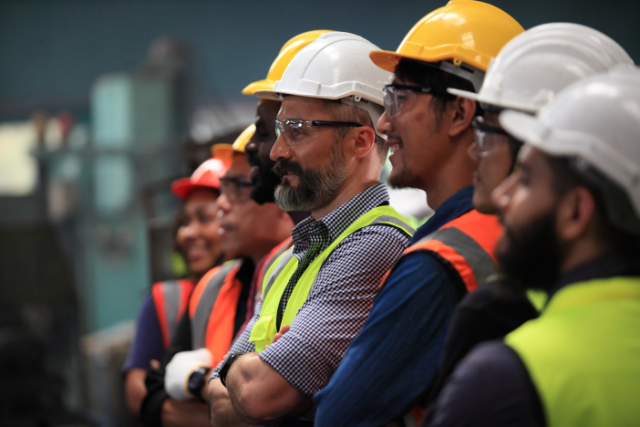 Maintenance workers standing in a line or in a meeting 