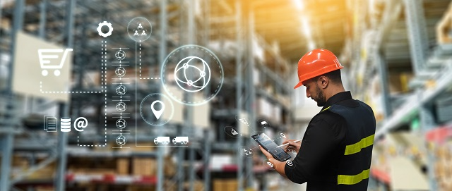 Warehouse worker analyzing inventory data on a tablet PC 