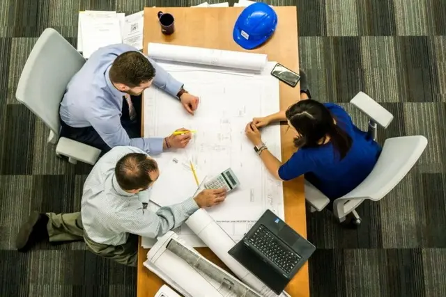 Overhead view of a facilities management meeting