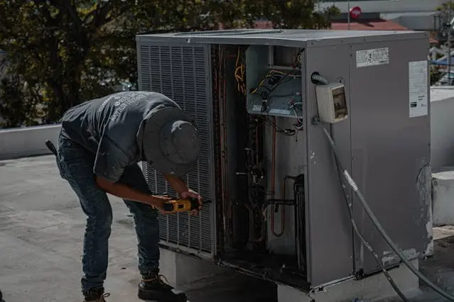 Maintenance being performed on an external AC unit