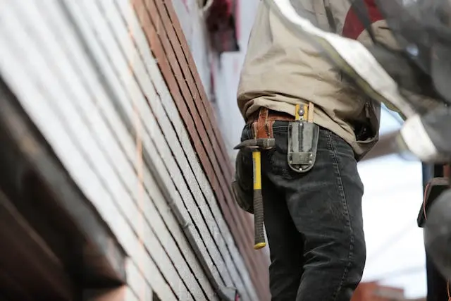 A maintenance worker wearing a toolbelt