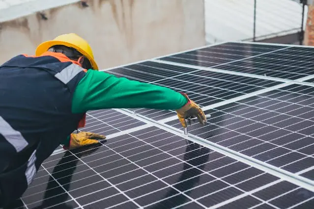 A technician installing solar panels