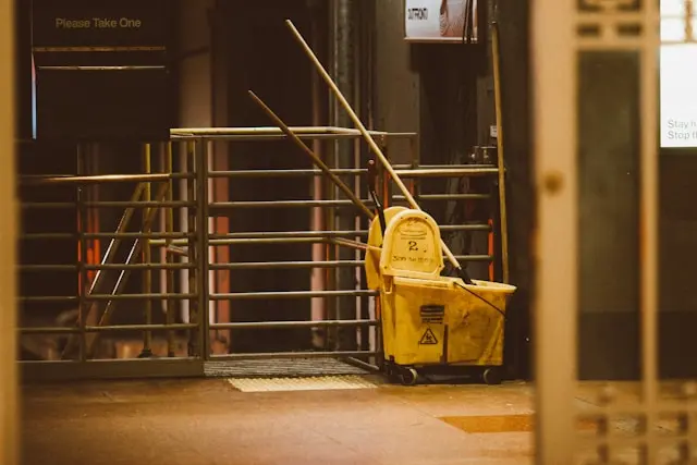 A yellow cleaning cart in a factory